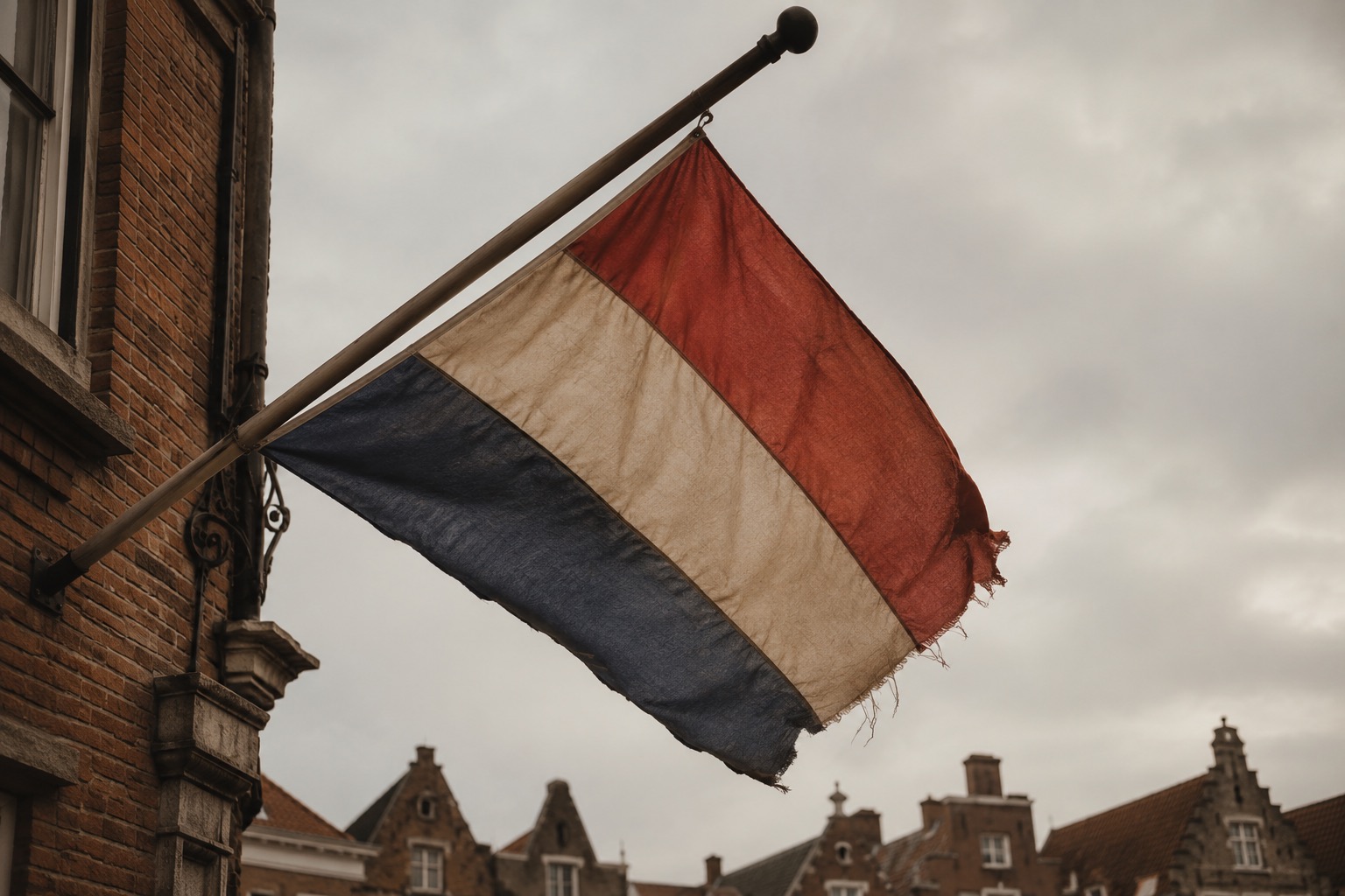 A weathered Dutch flag — red, white and blue horizontal stripes.
